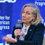 A seated Abigail Spanberger makes a point while speaking at a gathering for the Center for American Progress.