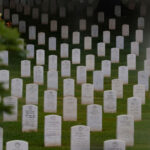 Headstones are seen through a foggy window ahead of members of the 3rd U.S. Infantry Regiment placing flags in front of each headstone at Arlington National Cemetery on May 21, 2026 in Arlington, Virginia. Before dawn soldiers begin the process of placing a flag in front of approximately 260,000 headstones ahead of Memorial Day. (Photo by Heather Diehl/Getty Images)