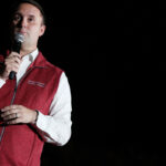 Former Virginia Attorney General Jason Miyares, wearing a red vest, speaks.