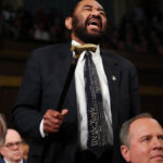 Rep. Al Green shakes his cane and screams toward President Trump.
