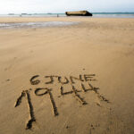 The date 6 June 1944 written in the sand of the beaches of Normandy, France.