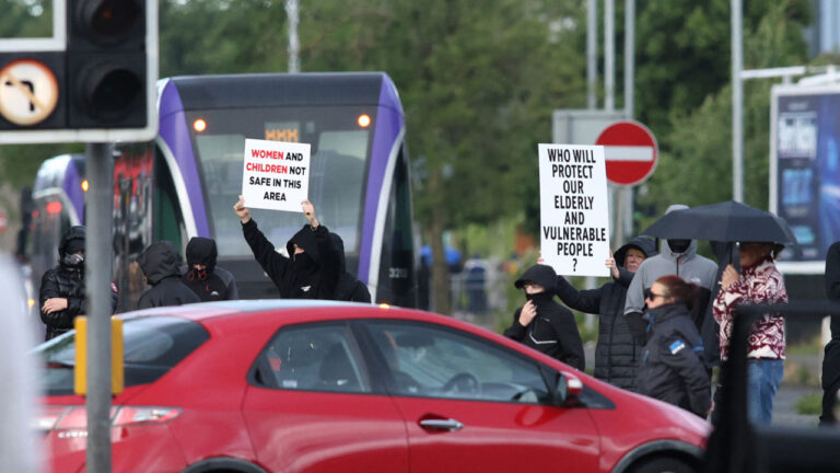 Protesters start to gather, blocking roads in central Belfast, Northern Ireland, in the evening of June 9, 2026. Northern Ireland police said on June 9, 2026 they had arrested a man following what Prime Minister Keir Starmer branded a "sickening" stabbing in Belfast, with graphic video prompting protest calls from UK far-right figures. Video of the June 8, 2026 incident posted on social media networks shows a man straddling another man lying in a street and slashing him several times in the head and neck with a knife in what appears to be an attempted beheading. (Photo by Paul Faith / AFP via Getty Images)