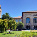 The campus of Stanford University against a blue sky.