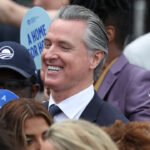 A smiling Gavin Newsom amid a group of people.
