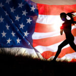 silhouette of a woman running up a small hill with graphic of American flag behind her, with sun shining through the flag's stripes.