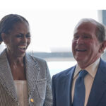 Michelle Obama and George W. Bush share a laugh.