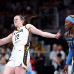 Caitlin Clark loses her balance after being fouled.