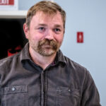 Graham Platner in a brown work shirt.