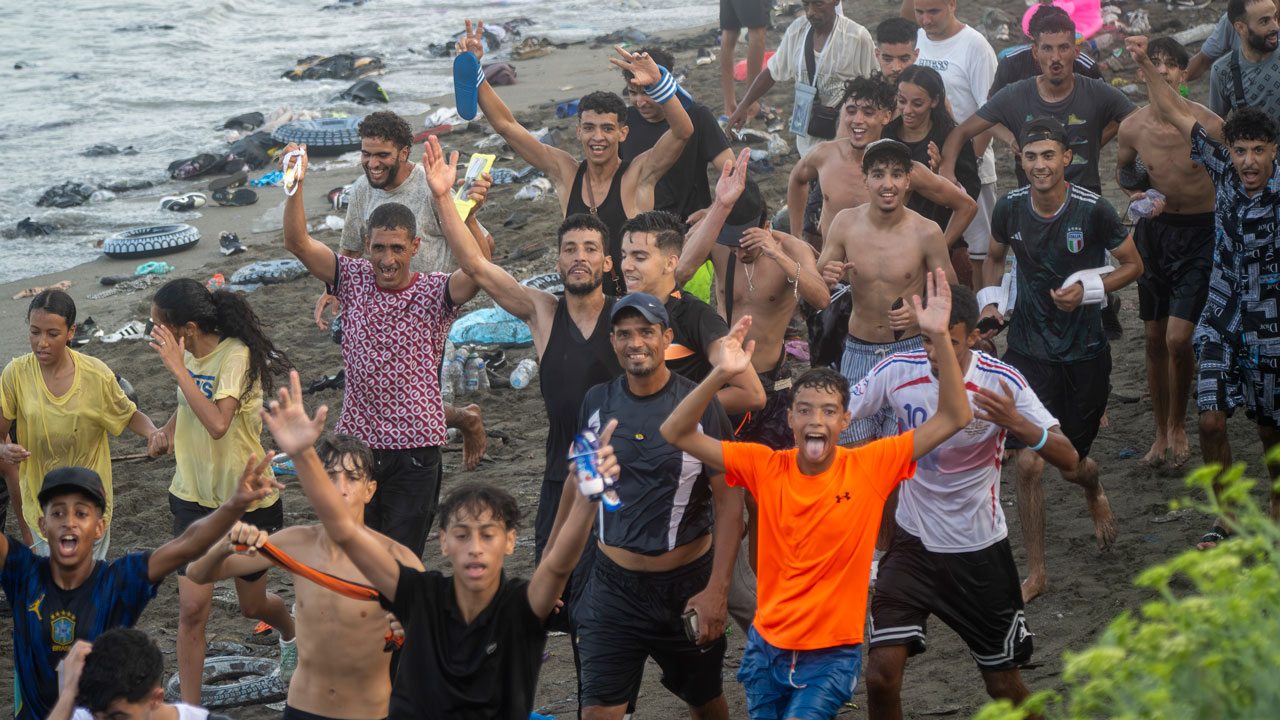 Dozens of migrants celebrate having crossed the border between Ceuta and Morocco, on 31 July, 2026 in Ceuta, Spain. Numerous people continued to enter Ceuta from Morocco in an uncontrolled manner as night fell on Thursday, 30 July. From early in the morning, thousands of migrants had entered the autonomous city by swimming and also on foot, skirting the breakwater that separates the autonomous city from Morocco. The units responsible for border control in Ceuta have recovered the bodies of 16 people from the water in the last 24 hours, bringing the total to 47 foreign nationals found dead in Ceuta’s waters whilst attempting to swim across from Morocco so far this year. (Photo By Marcos Moreno/Europa Press via Getty Images)