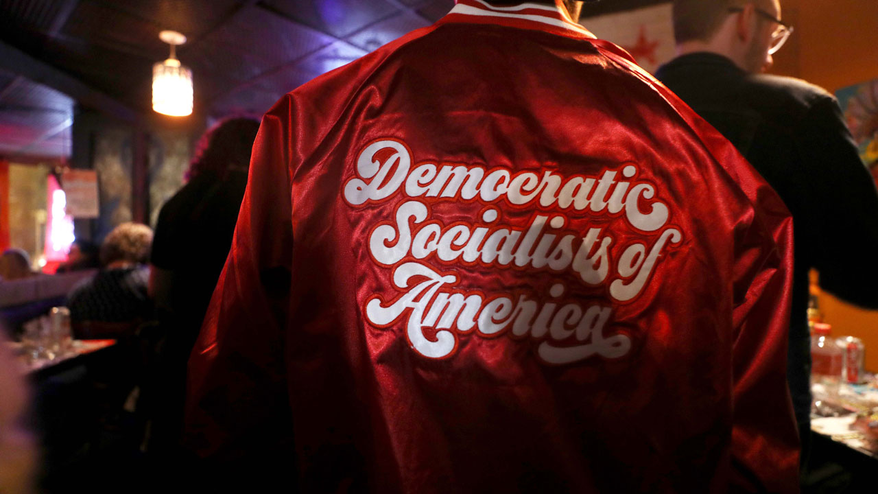 An attendee wears a jacket at an Iowa caucus watch party with supporters of Democratic presidential candidate Sen. Bernie Sanders (I-VT), organized by Metro D.C. Democratic Socialists of America, on February 3, 2020 in Washington, DC. Iowa holds its caucuses this evening as the first contest in the 2020 presidential nominating process with the candidates then moving on to New Hampshire. (Photo by Mario Tama/Getty Images)