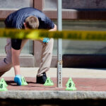 Police investigate on Cambridge Street outside offices of Massachusetts General Hospital on May 27, 2025 after a police-involved shooting. (Photo by Lane Turner/The Boston Globe via Getty Images)