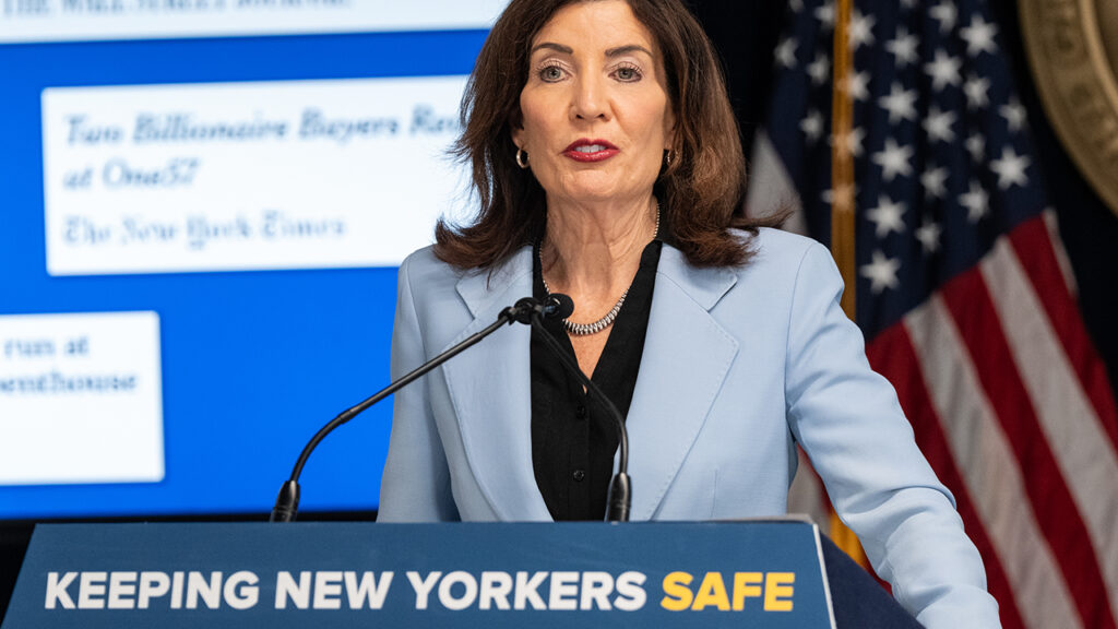 Kathy Hochul Speaking Behind a Podium that Says "Keeping New Yorkers Safe"