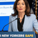 Kathy Hochul Speaking Behind a Podium that Says "Keeping New Yorkers Safe"