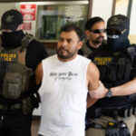 Immigration and Customs Enforcement agents walk a detainee out of the Ventura County Government Center in Ventura, California, on July 27, 2026. (Blake Fagan / AFP via Getty Images)
