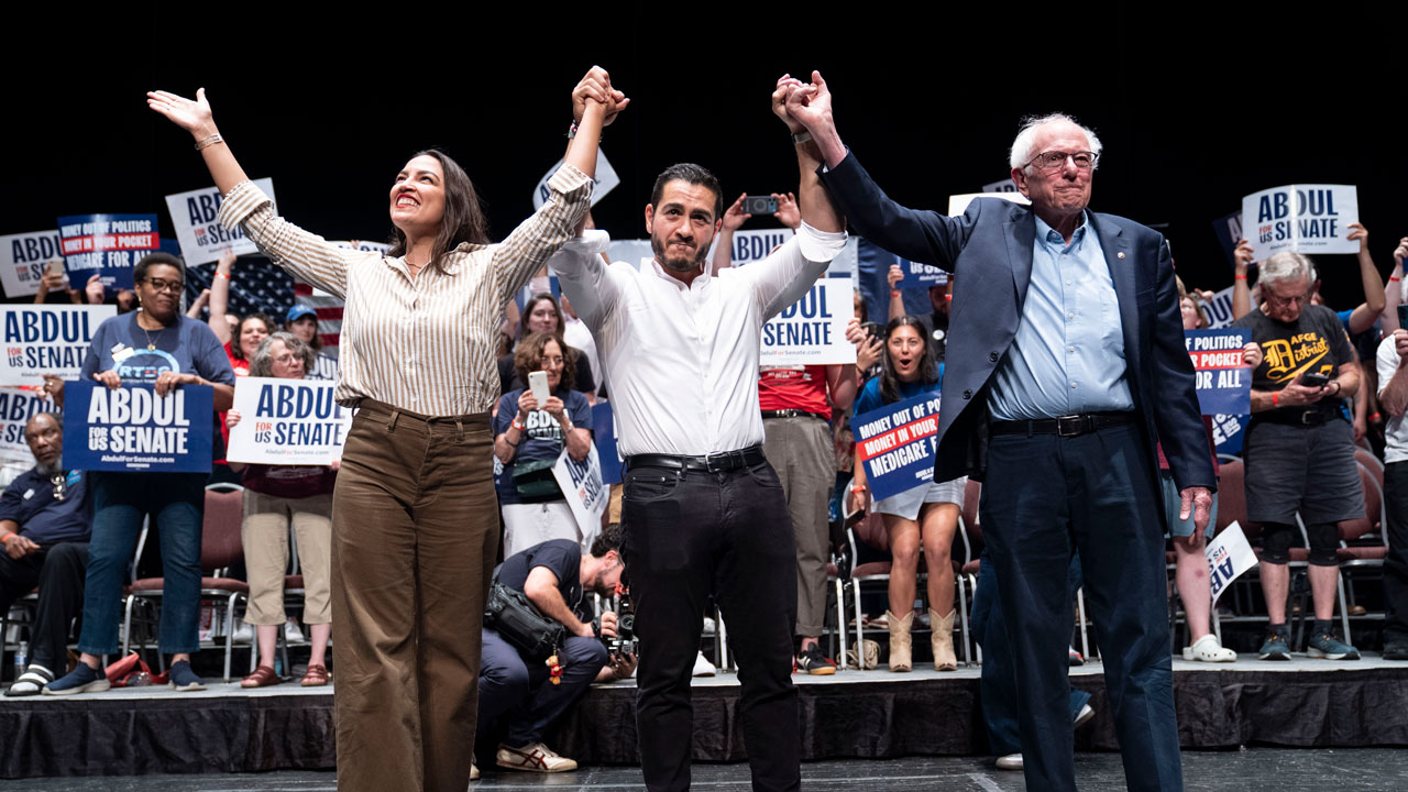 Home 3 Alexandria Ocasio-Cortez (D-NY), Michigan Democratic candidate for Senate Abdul El-Sayed and U.S. Sen. Bernie Sanders (I-VT) raise their arms during a rally.