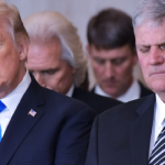 Donald Trump stands next to Franklin Graham in the US Capitol Rotunda, both bowing their heads in prayer.