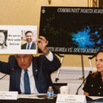 Rep. Carlos Gimenez, R-Fla., holds sign comparing Xohran Mamdani to Cuba's dictator Fidel Castro.