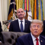 Sen. John Curtis (R-UT) (L), Sen. Mike Lee (R-UT) (C), and Utah Gov. Spencer Cox (R) stand behind U.S. President Donald Trump.