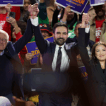 New York City mayoral candidate Zohran Mamdani (C) holds hands with US Senator Bernie Sanders (I-VT) (L) and US Representative Alexandria Ocasio-Cortez (D-NY) at the end of a campaign rally at Forest Hills Stadium in the Queens borough of New York City on October 26, 2025. New Yorkers will cast their votes for mayor on November 4, 2025. Mamdani, the Democratic candidate, is the current frontrunner ahead of former New York Governor and independent candidate Andrew Cuomo and Republican candidate Curtis Sliwa. (Photo by ANGELA WEISS / AFP) (Photo by ANGELA WEISS/AFP via Getty Images)