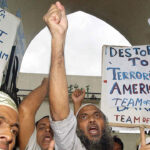 A group of angry anti-US protesters from the "Team of Allah" chant slogans calling for the death of US President George Bush in Dhaka, in 2002.