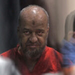 Senior Egyptian Muslim Brotherhood member Mohamed el-Beltagi is seen behind bars during a verdict and sentencing session of a retrial for him and other Brotherhood members.