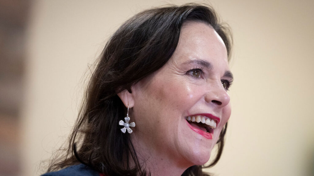 Jane Timken looks to the side and smiles.