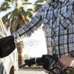 A man pumps gas.