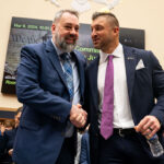 Tim Tebow, Founder of the Tim Tebow Foundation is greeted by Jim Cole, retired Homeland Security Investigations supervisor.