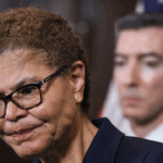 Karen Bass stands with a worried face.