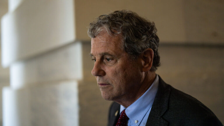 Then Sen. Sherrod Brown, D-Ohio, looks off to the side.
