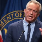 Robert F. Kennedy Jr. speaking while holding up his hand