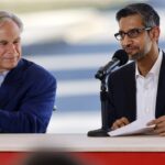 Texas Governor Greg Abbott and Alphabet and Google CEO Sundar Pichai sit at a table with microphones.