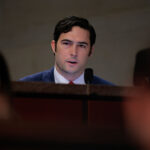 Rep. Brandon Gill looks out from the table as he appears at a House committee hearing.