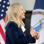 Virginia Gov. Abigail Spanberger stands smiling.