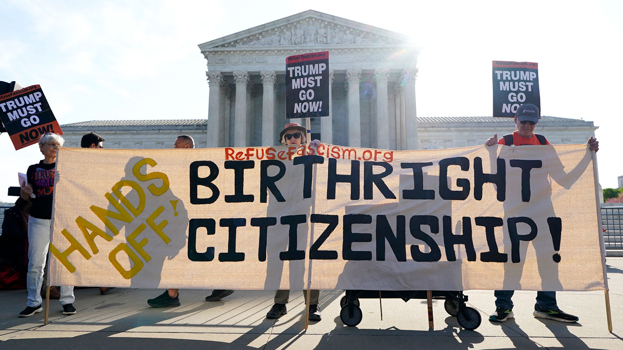 Home 1 Protesters hold a large Hands Off Birthright Citizenship banner in front of the U.S. Supreme Court, with others holding Trump Must Go Now! signs in the background.