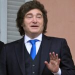 Argentina's President Javier Milei holding up his hand