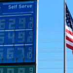 Six-dollar gas is displayed at a California gas station with the American flag in the background.