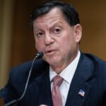 Frank Bisignano speaking into a microphone