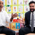 Barack Obama and Zohran Mamdani singing and moving their hands in a classroom