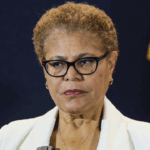 Karen Bass stands with a straight face.