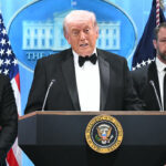 President Donald Trump speaks, flanked by FBI Director Kash Patel and US Secretary of Homeland Security Markwayne Mullin, during a press briefing in the Brady Briefing Room at the White House in Washington, DC, shortly after a shooting incident at the White House Correspondents’ Dinner on April 25, 2026.