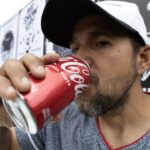 A man drinking soda
