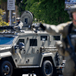 Federal authorities stand in MacArthur Park in Los Angeles.