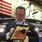 A trader working on the floor of the New York Stock Exchange