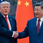 Donald Trump (R) shakes hands with China's President Xi Jinping