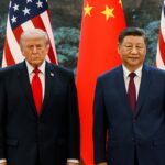 Donald Trump and Xi Jinping standing in front of flags