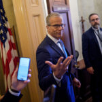 Senate Majority Leader John Thune (R-SD) gestures while speaking to reporters as he walks into his office at the U.S. Capitol Building on May 21, 2026 in Washington, DC.
