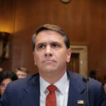 Acting U.S. Attorney General Todd Blanche seated