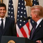 Donald Trump and Kevin Warsh in front of several American flags.