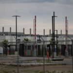 An outside view of a data center in Hilliard, Ohio behind a fence.
